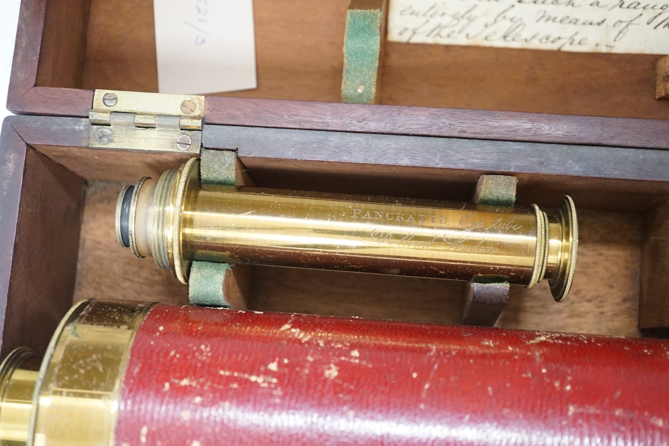 A cased early 19th century brass astronomical telescope, by Dollond, London, with separate screw fitting ‘Pancratic eye tube’ and other optics with sun filters, case 40cm